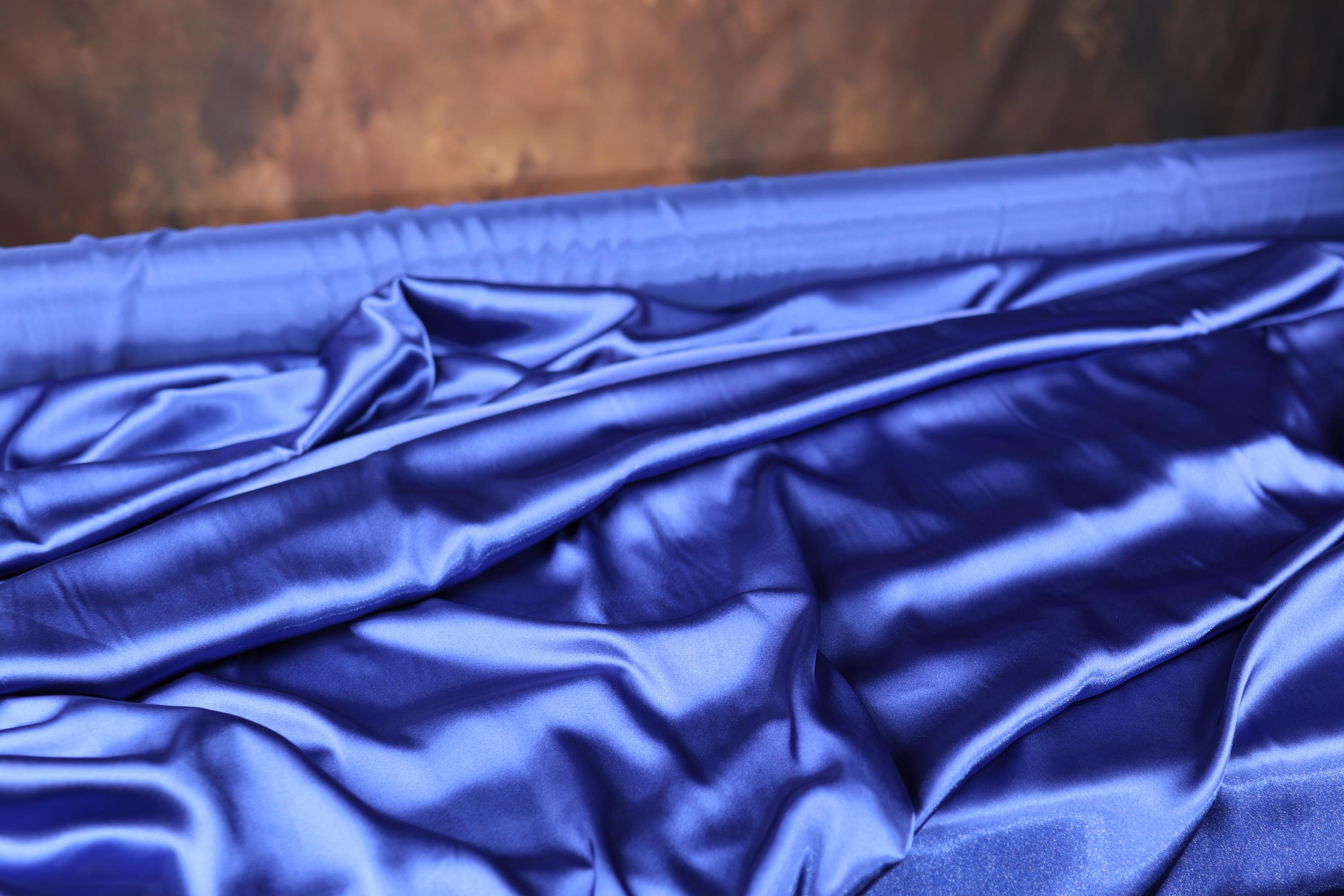 a close up of a blue sheet on a bed