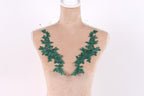 A mannequin with green leaf-shaped embroidery on its bust area.
