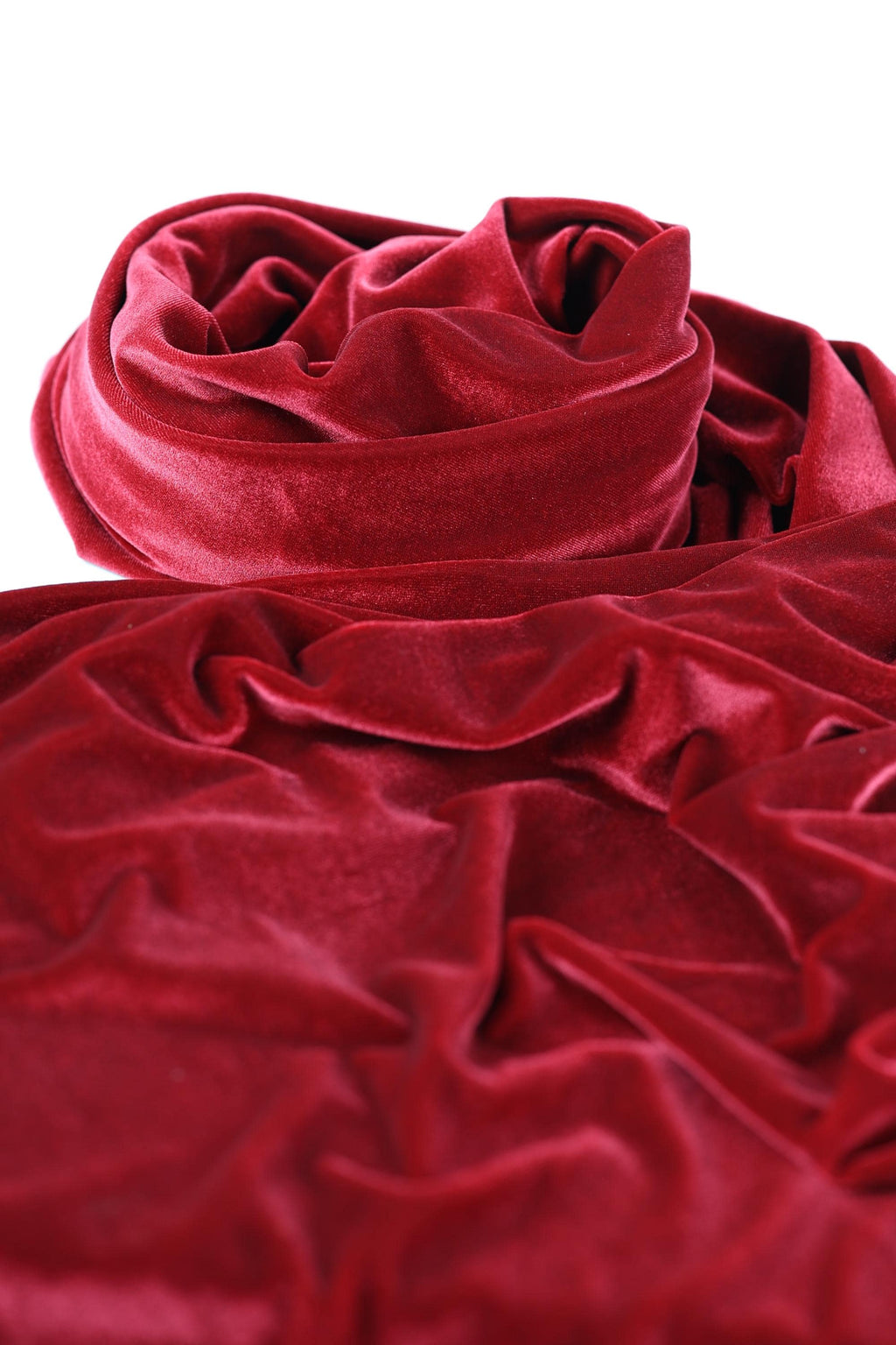 a close-up view of a red velvet fabric, with its folds and creases visible.