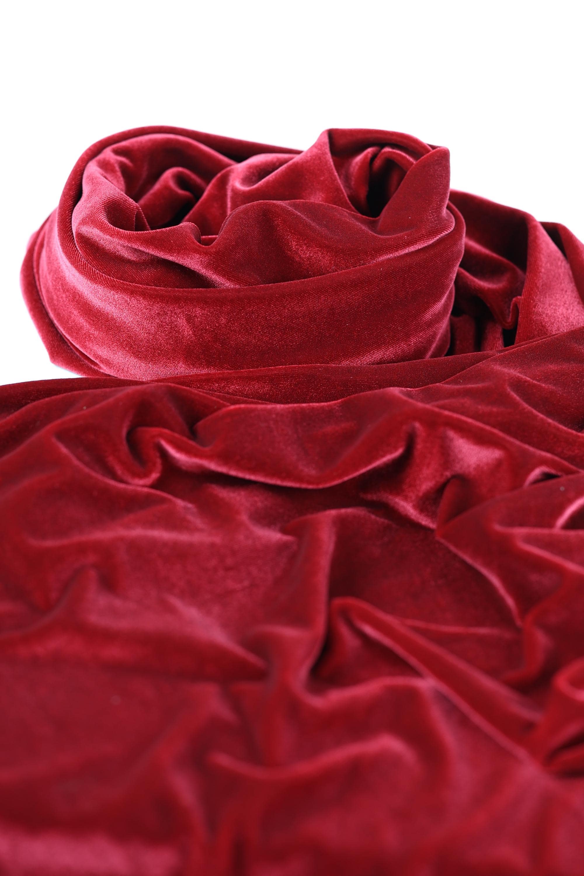 a close-up view of a red velvet fabric, with its folds and creases visible.