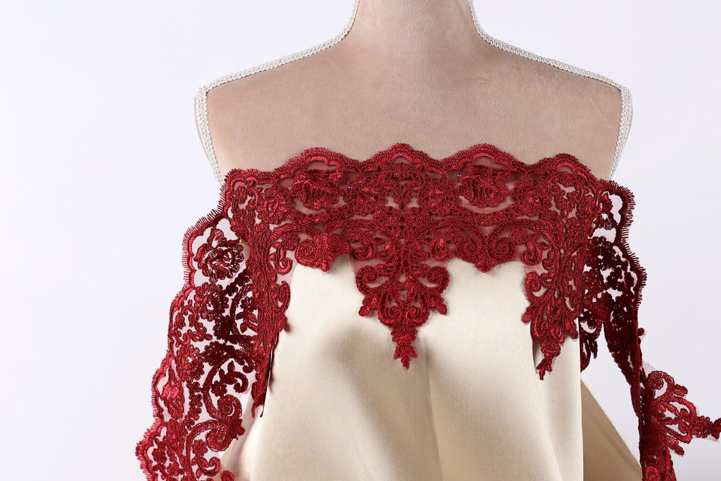A mannequin wearing a red lace dress with a beige bodice.