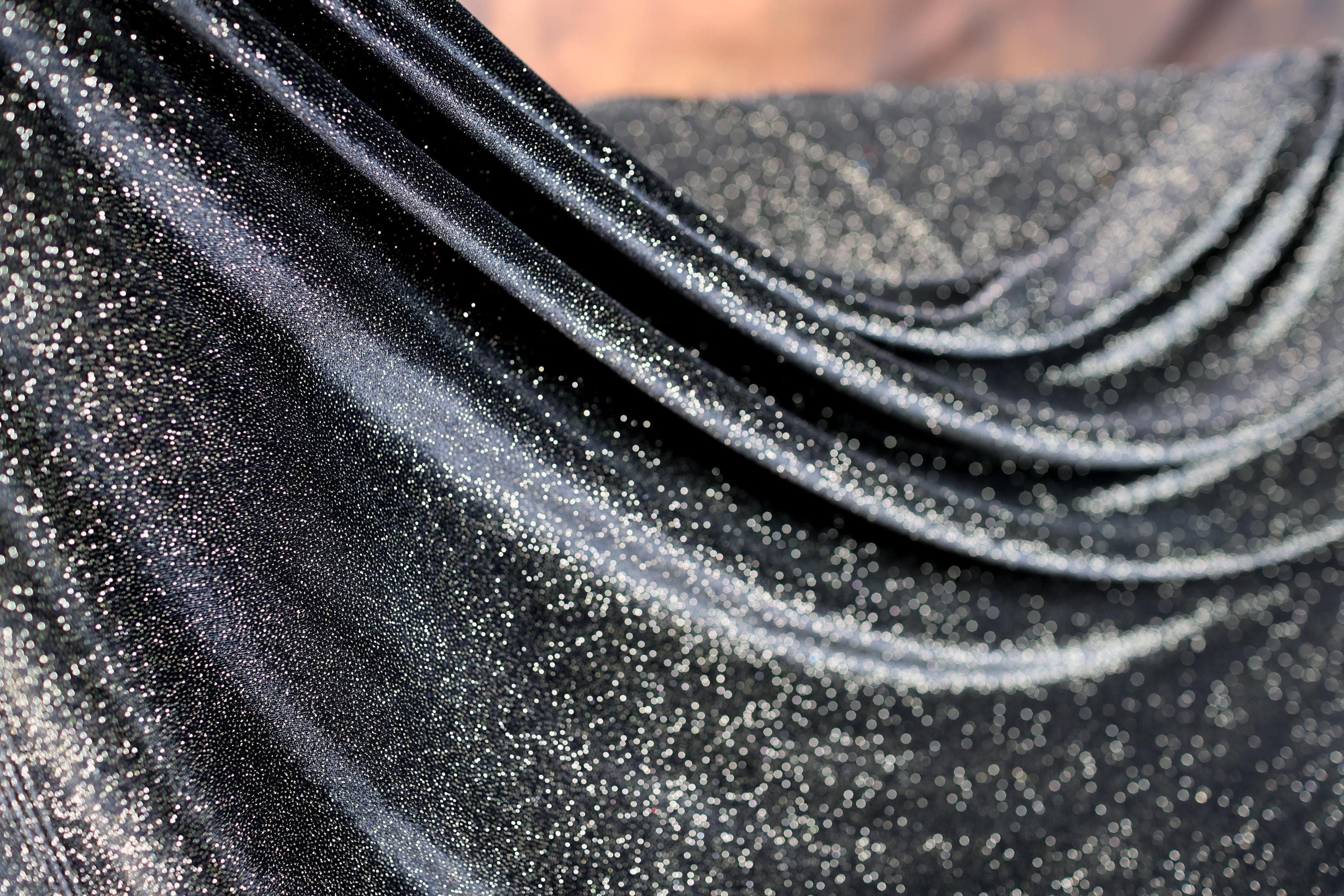 a close up of a black fabric with white speckles