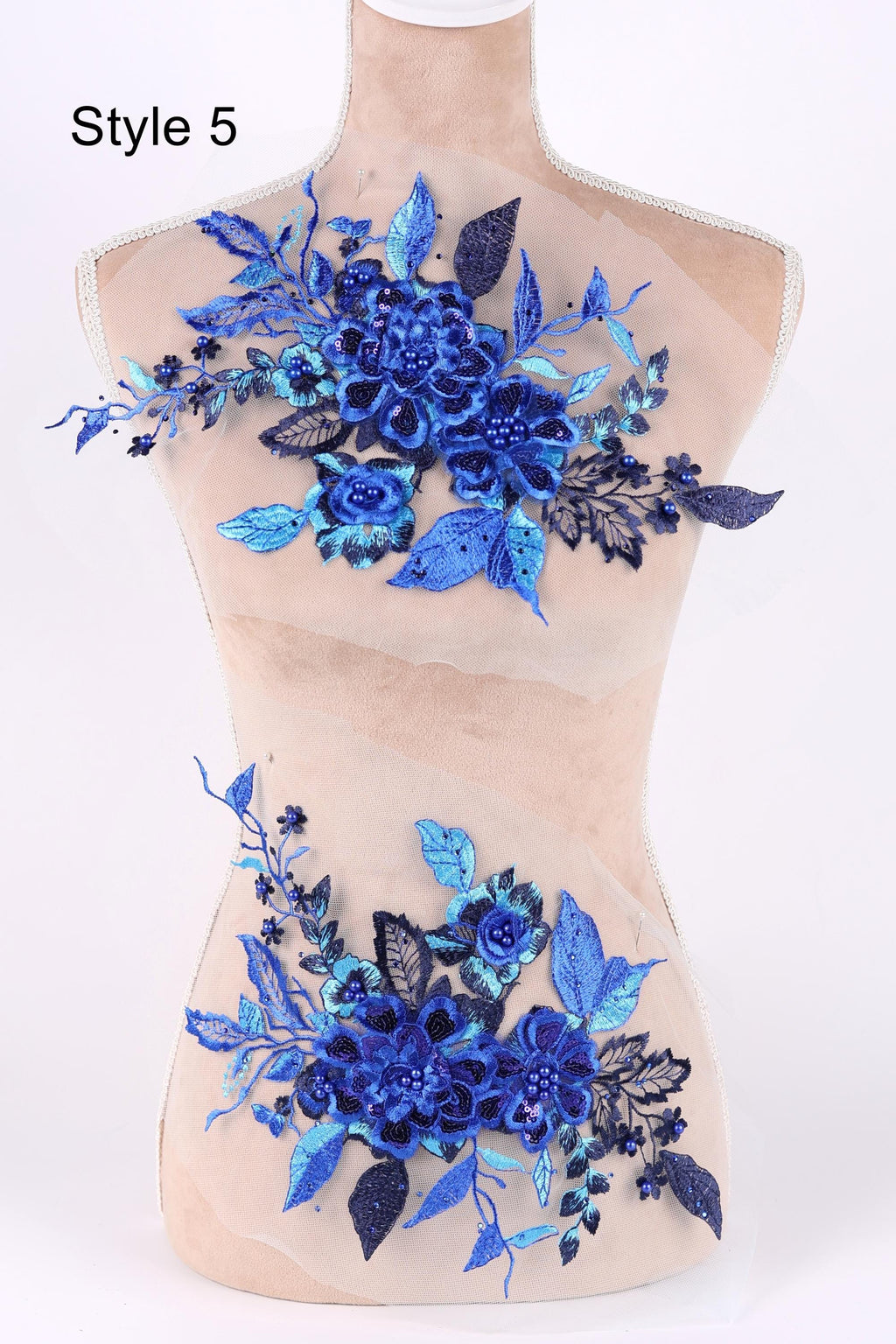 A mannequin with a floral design on its bust, featuring blue flowers and leaves.