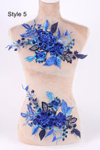A mannequin with a floral design on its bust, featuring blue flowers and leaves.