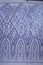 a close-up view of a fabric with a repeating pattern of blue sequin designs. The pattern consists of various shapes and lines, creating a visually striking and intricate design. The fabric appears to be a close-up of a piece of clothing or textile, showcasing the detailed craftsmanship and attention to detail in the design.