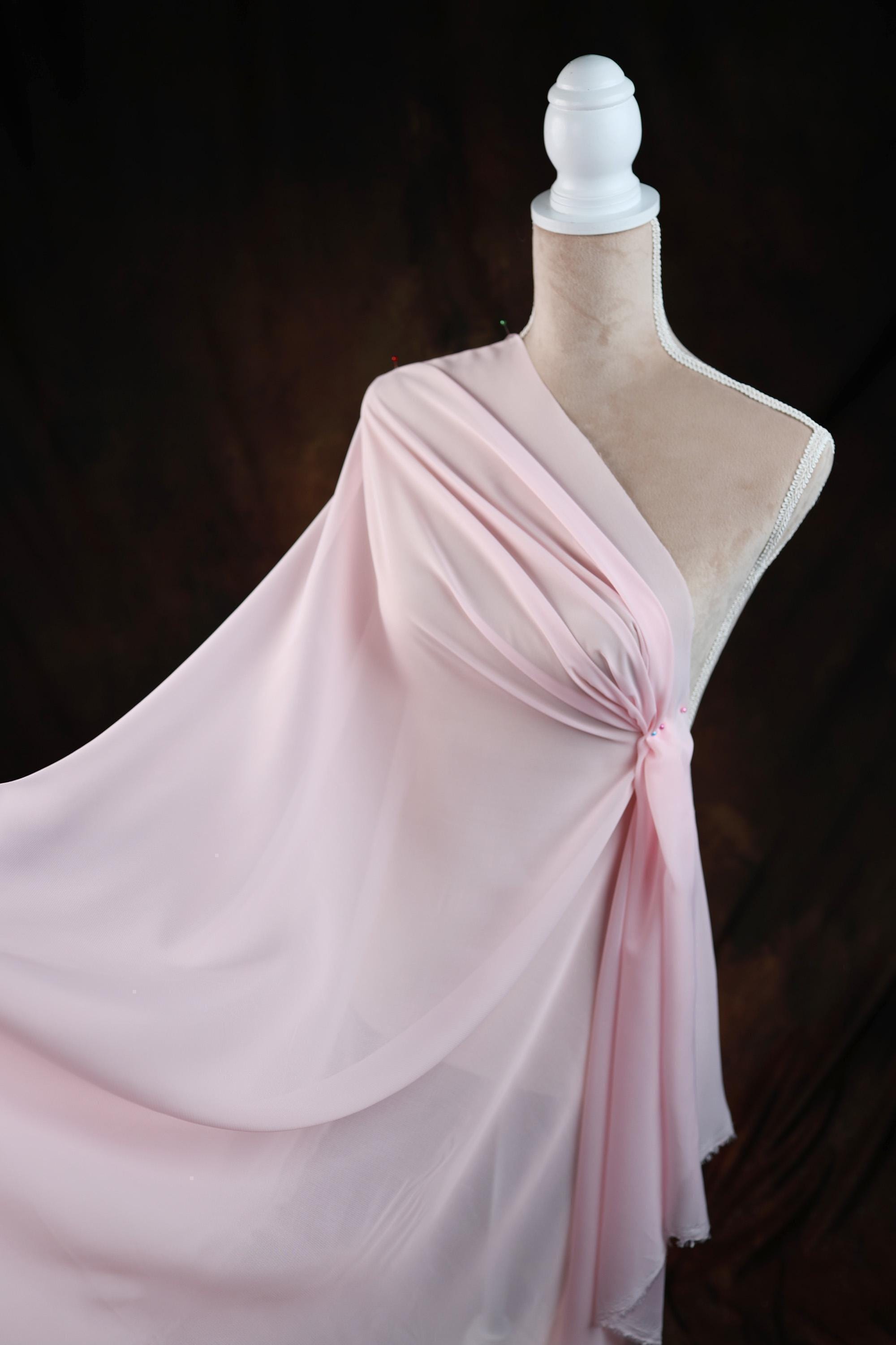 a dress on a mannequin on a black background