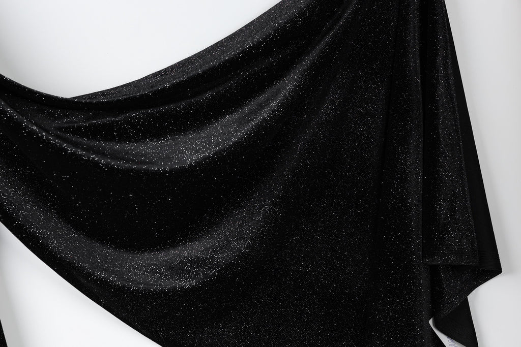a black fabric with a shiny, glittery texture.