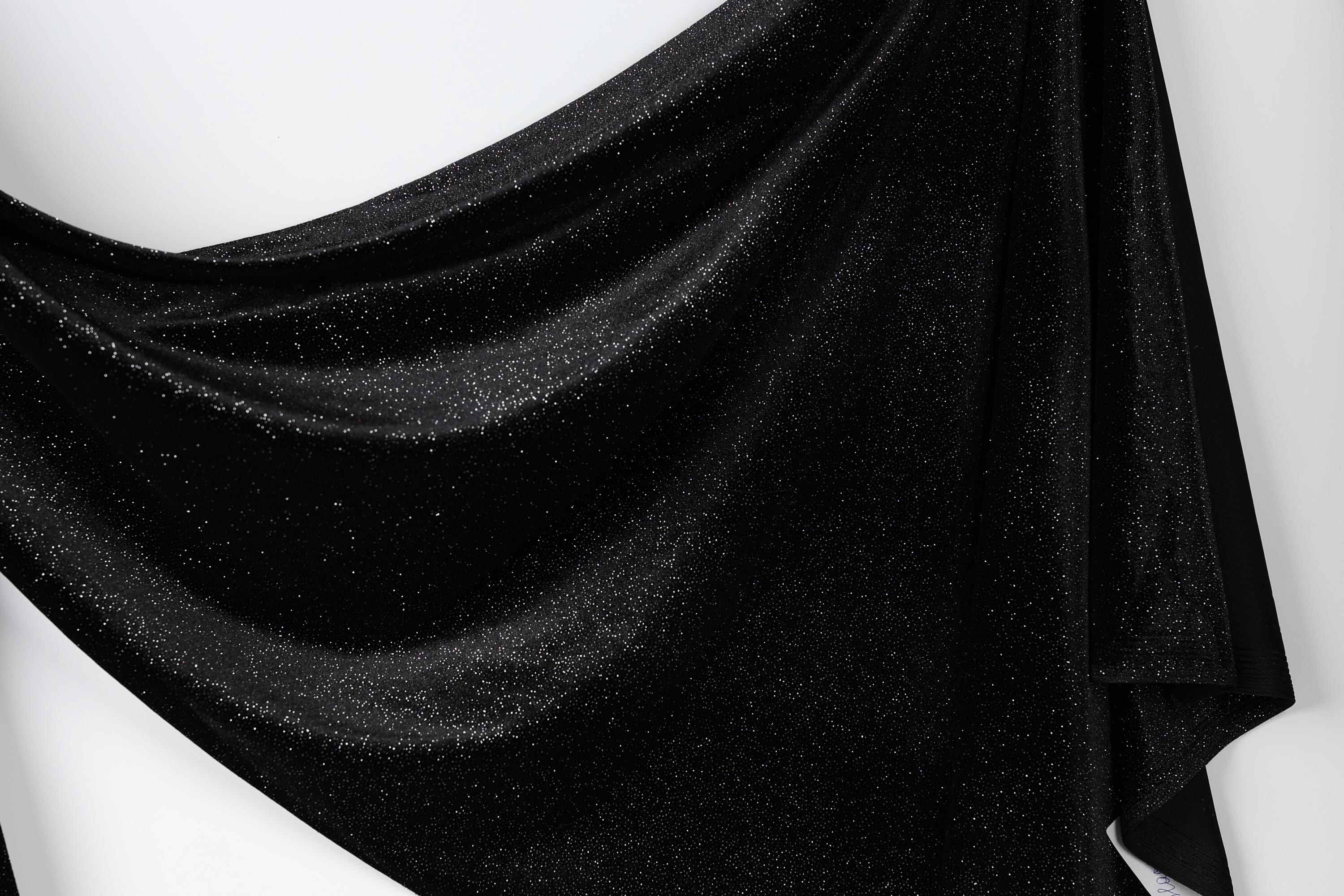 a black fabric with a shiny, glittery texture.