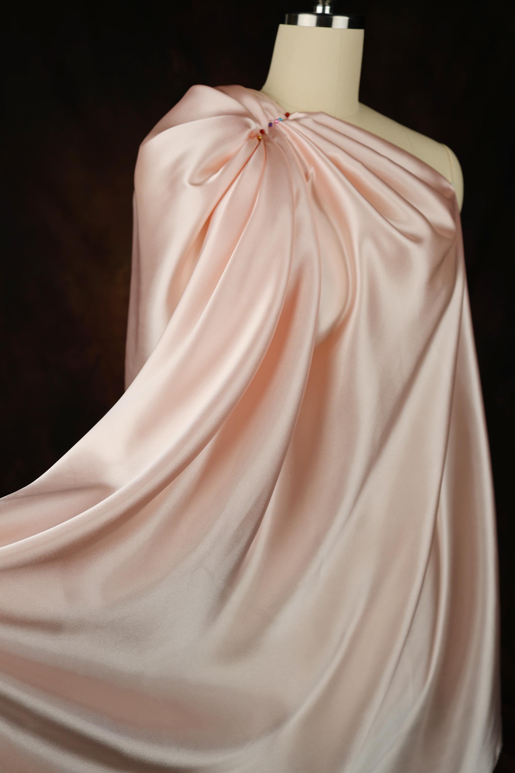 a dress on a mannequin on a black background