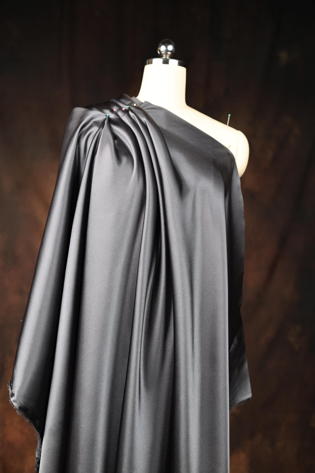 a mannequin with a black cape on it