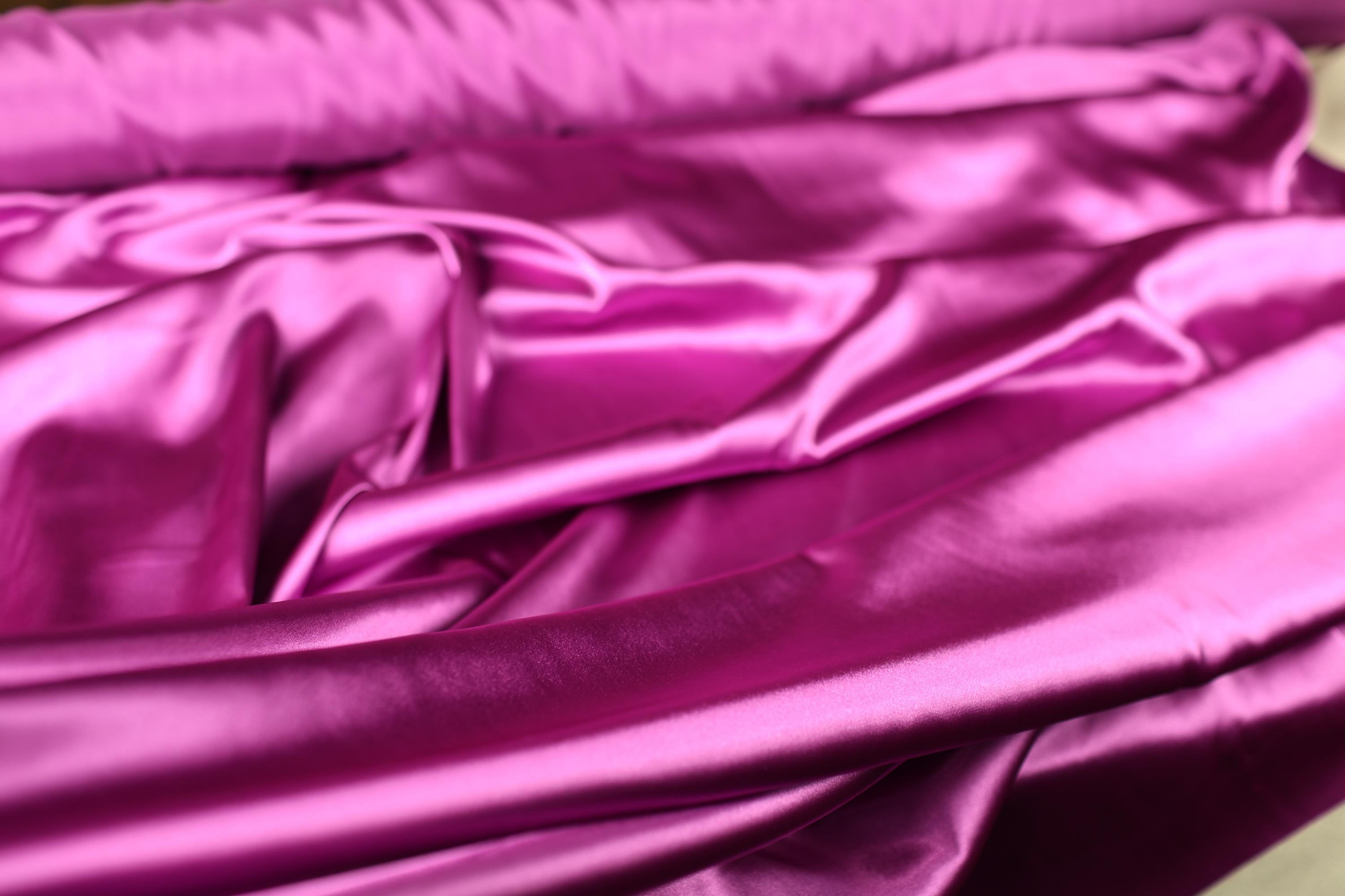 a close up of a pink satin material