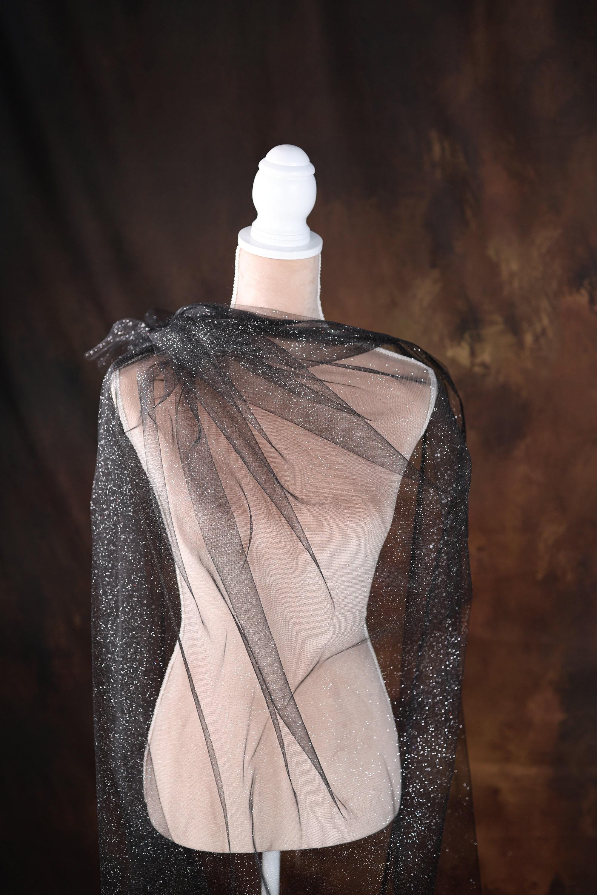 a mannequin with a black cape on top of it