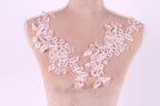 A mannequin with a pink floral lace design on its bust area.