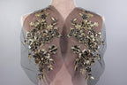 the back of a dress with gold flowers on it