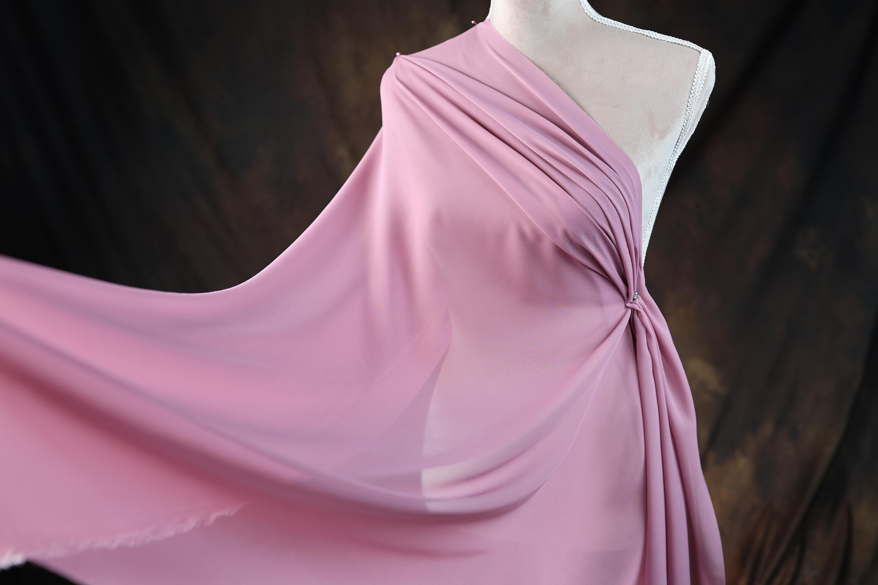 a dress on a mannequin on a wooden floor