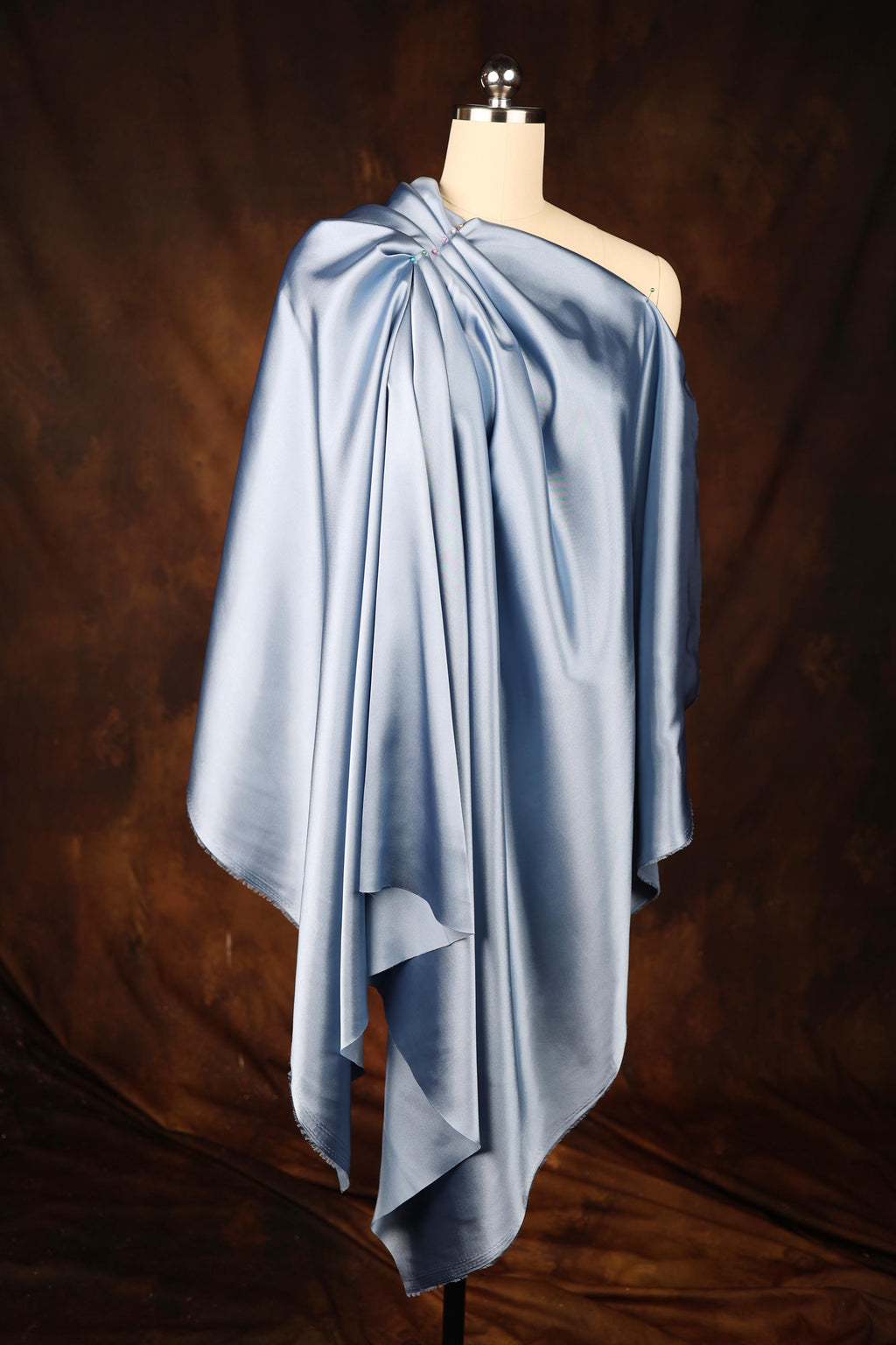 a dress on a mannequin on a brown background