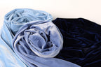 a close-up view of two fabric swatches, one blue and one navy blue, against a white background.
