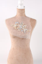 A mannequin with a delicate floral embroidered patch on its bust.