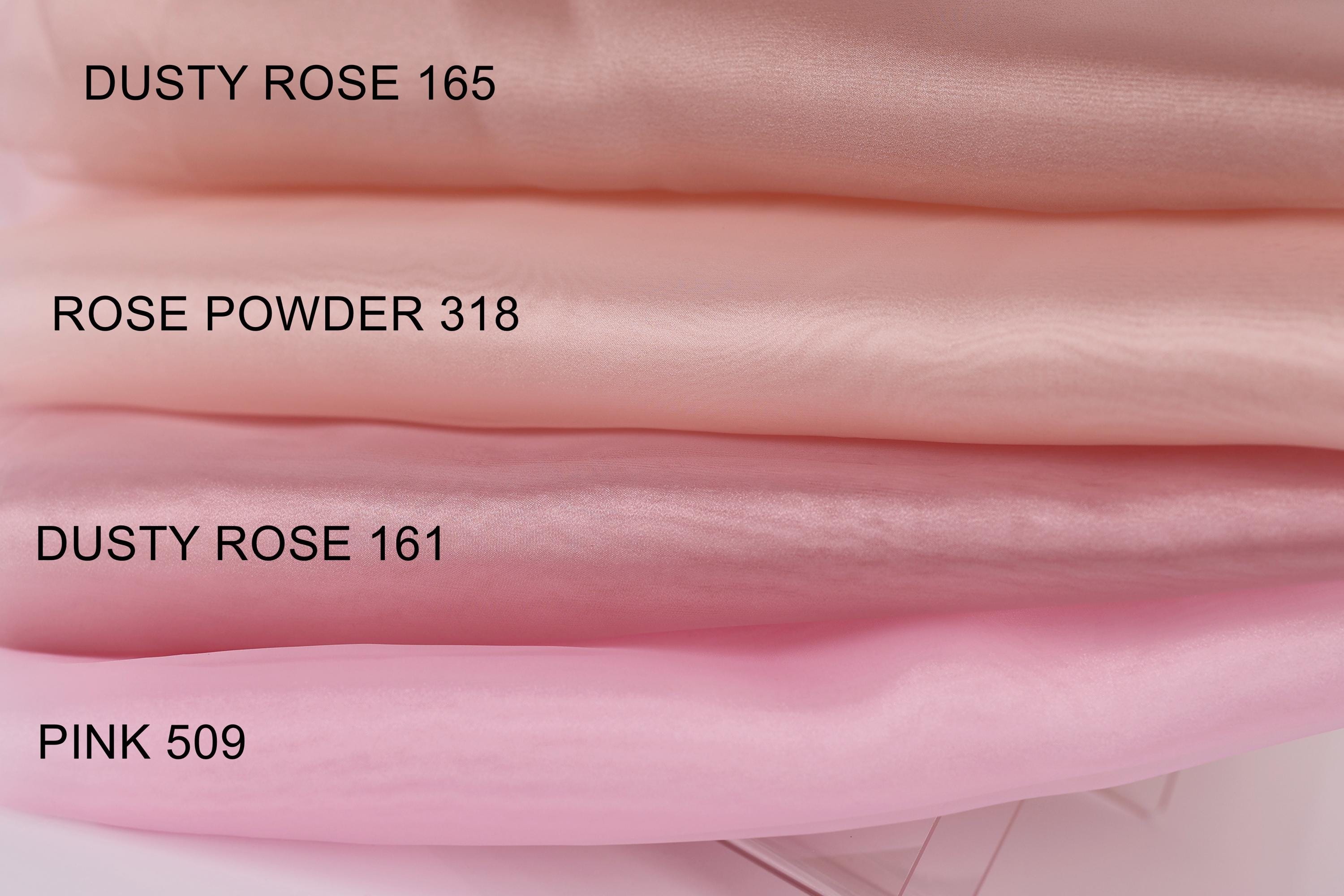 a close-up of a collection of fabric swatches in various shades of pink, ranging from dusty rose to rose powder.