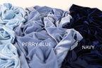 three different colored velvet fabrics, with the text "PERRY BLUE", "BLUE", and "NAVY" indicating the color of each fabric.