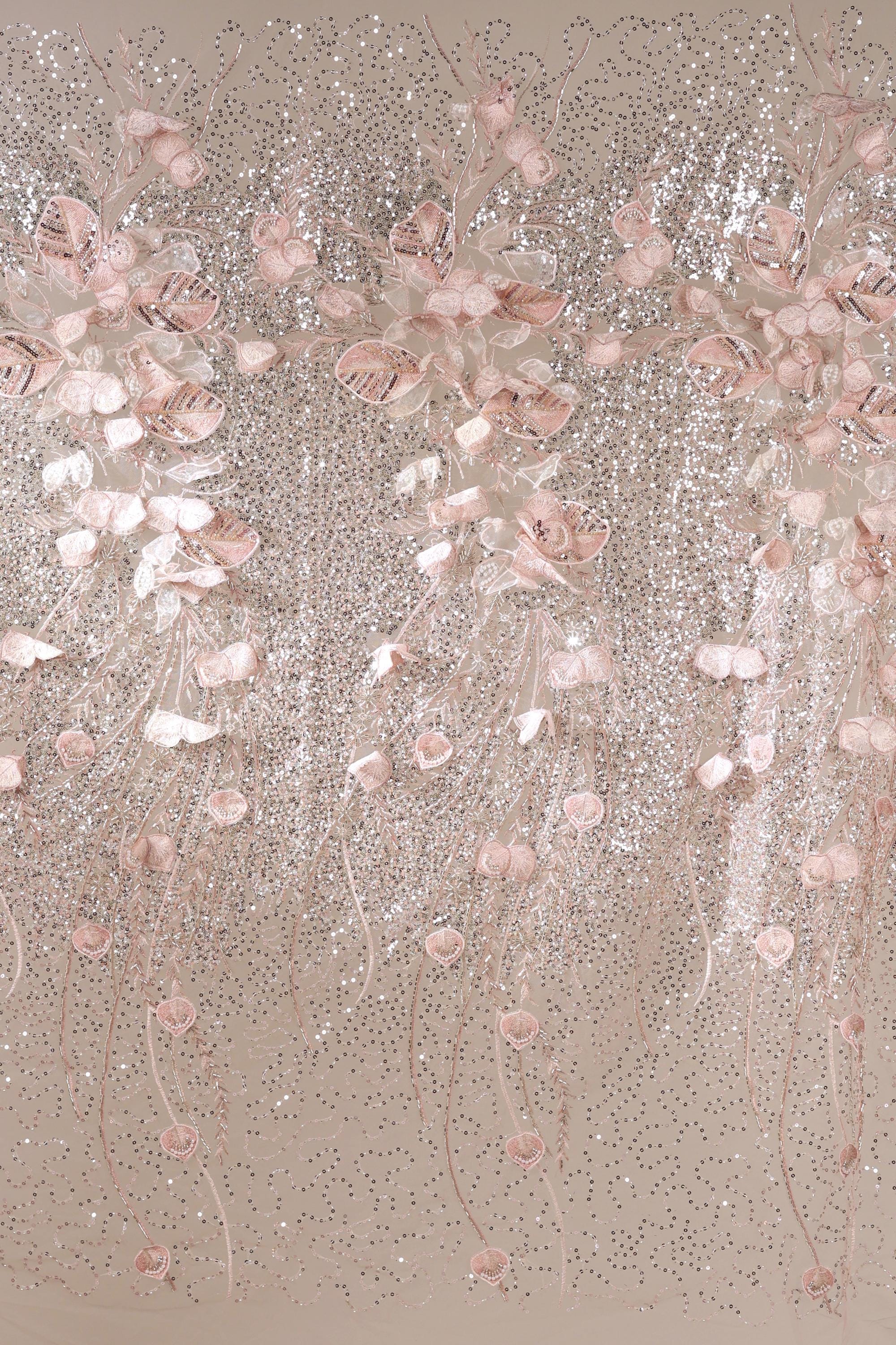 a decorative arrangement of pink and white flowers, with delicate petals and stems cascading down in a flowing, cascading pattern. The flowers are arranged in a way that creates a sense of movement and elegance, with the pink and white hues contrasting beautifully against the neutral background.