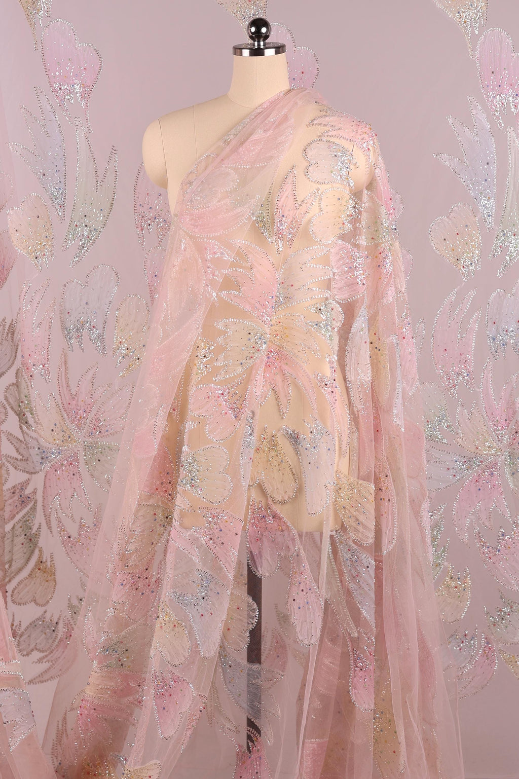 A mannequin wearing a pink and white floral print dress with a sheer, flowing skirt.