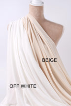 A mannequin wearing a white and beige fabric draped over its body, with the text "OFF WHITE" and "BEIGE" displayed on the fabric.