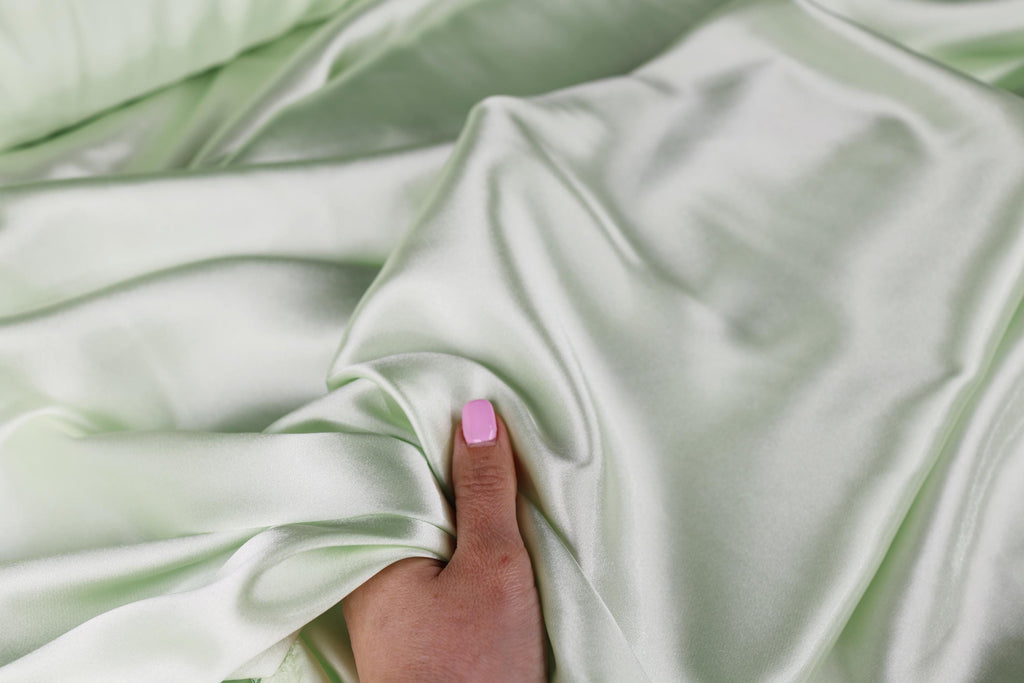 a woman&#39;s hand with a pink manicure on it
