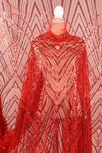 a red sequin fabric with a zigzag pattern, creating a visually striking and eye-catching design.