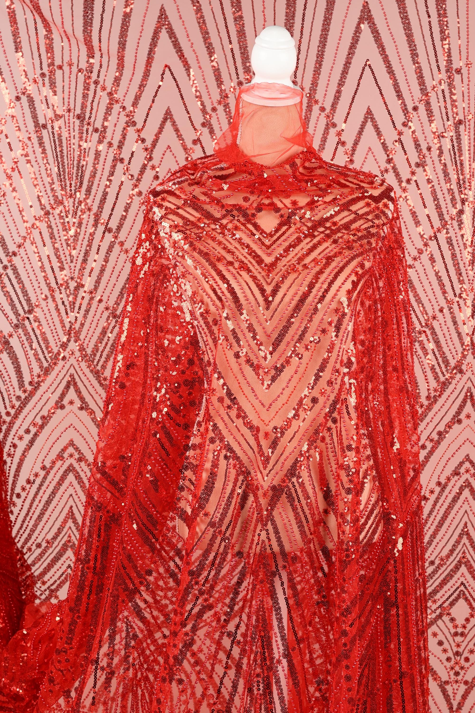 a red sequin fabric with a zigzag pattern, creating a visually striking and eye-catching design.