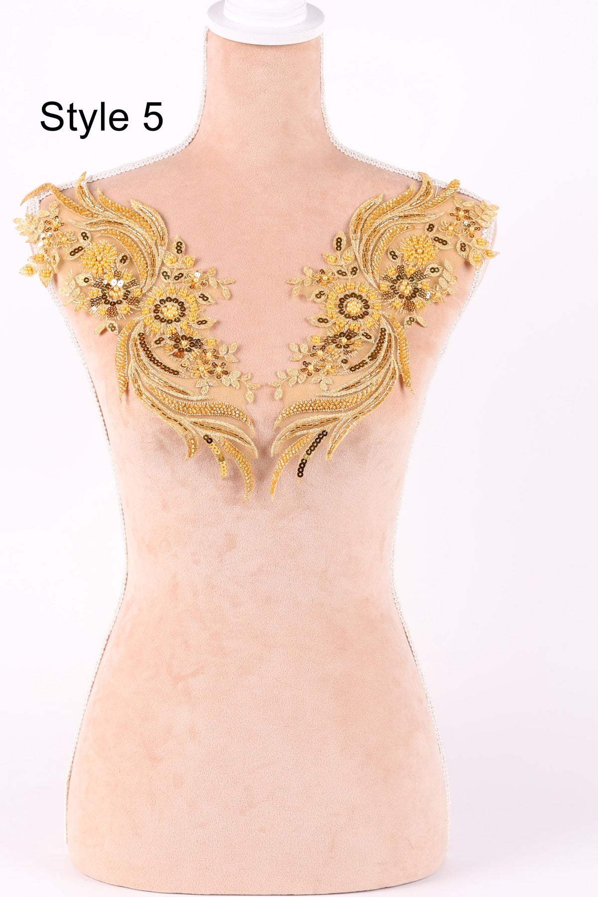 A mannequin with gold embroidered shoulder patches on its shoulders.