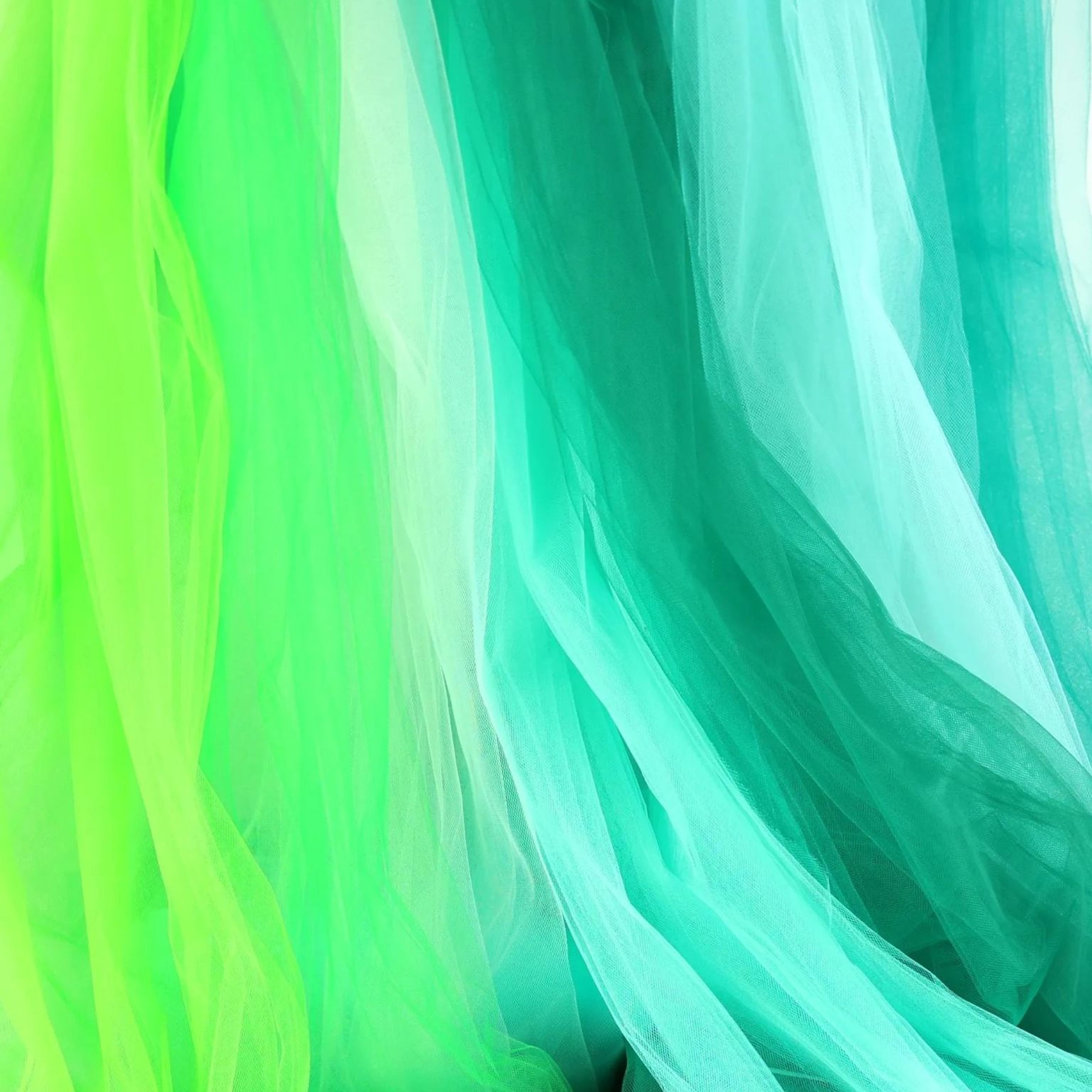 a close-up view of a piece of fabric with a vibrant mix of green and blue colors, creating a visually striking contrast.