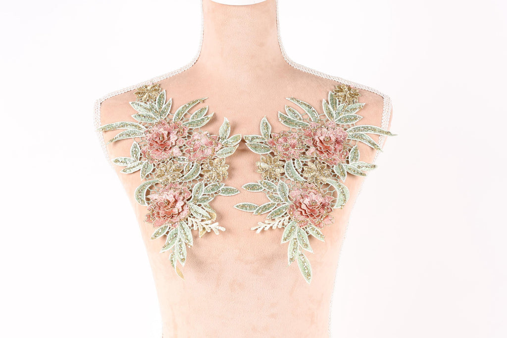 A mannequin with a floral design on its bust area, featuring pink and green flowers and leaves.