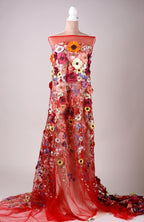 A mannequin wearing a long, red dress with a floral pattern.