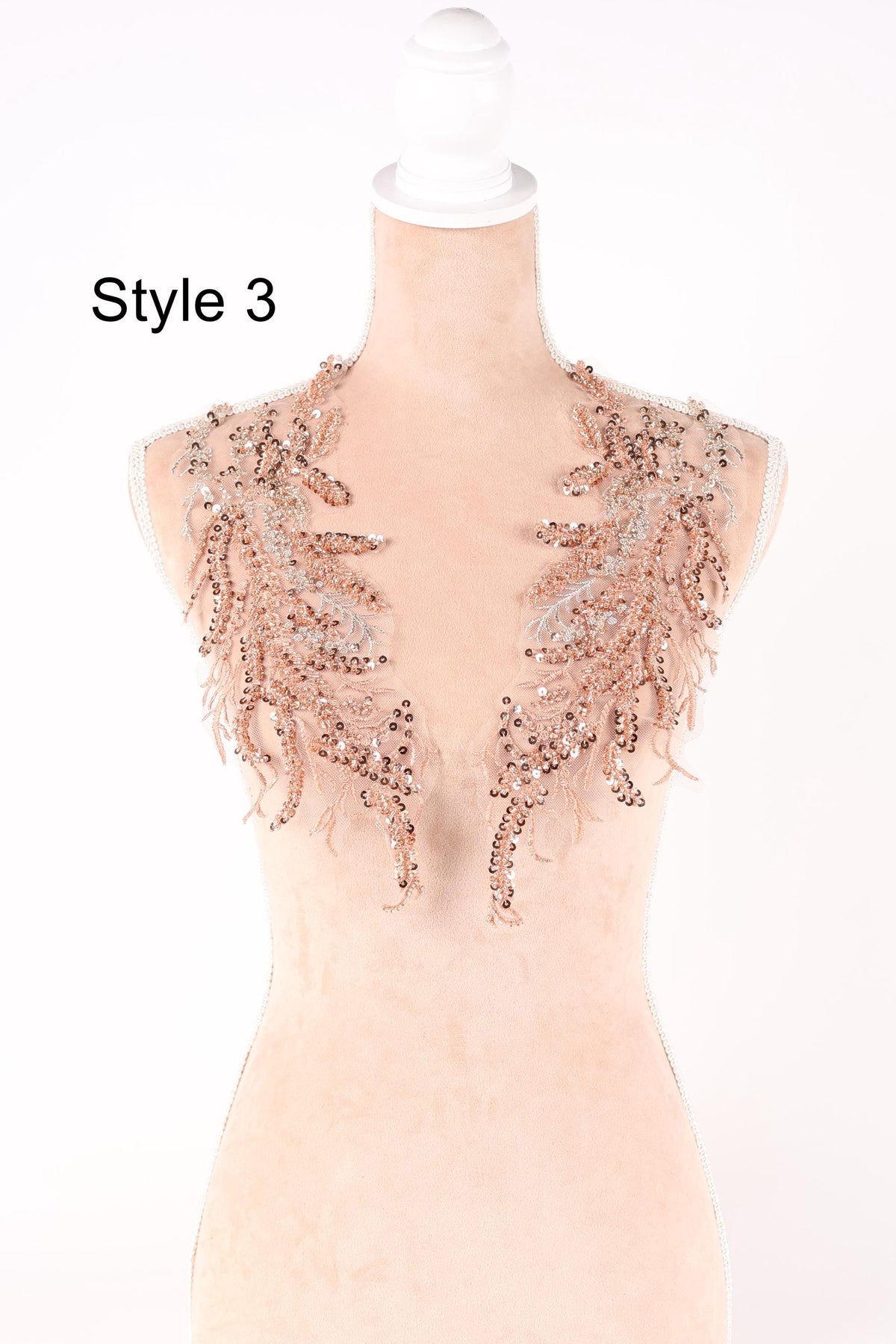 A mannequin wearing a decorative necklace with intricate beaded and sequined elements.