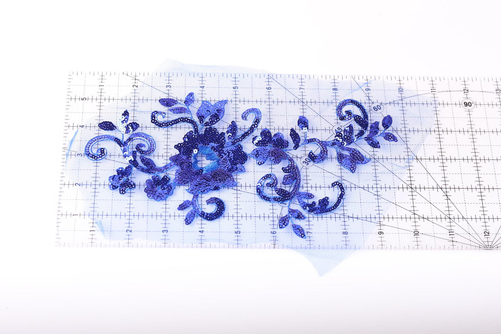 a clear ruler with a blue floral design on it.