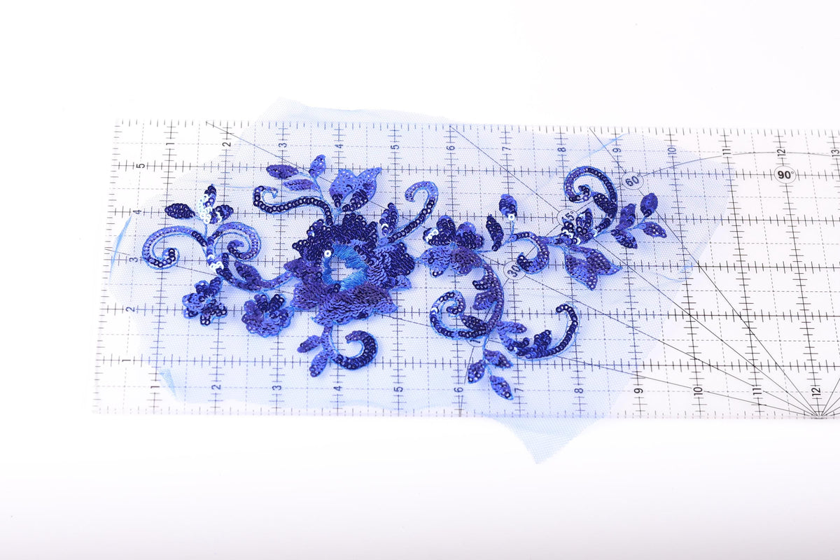 a clear ruler with a blue floral design on it.