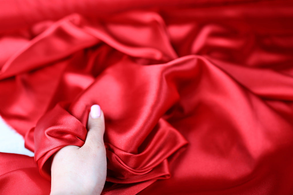 a person holding a red cloth in their hand