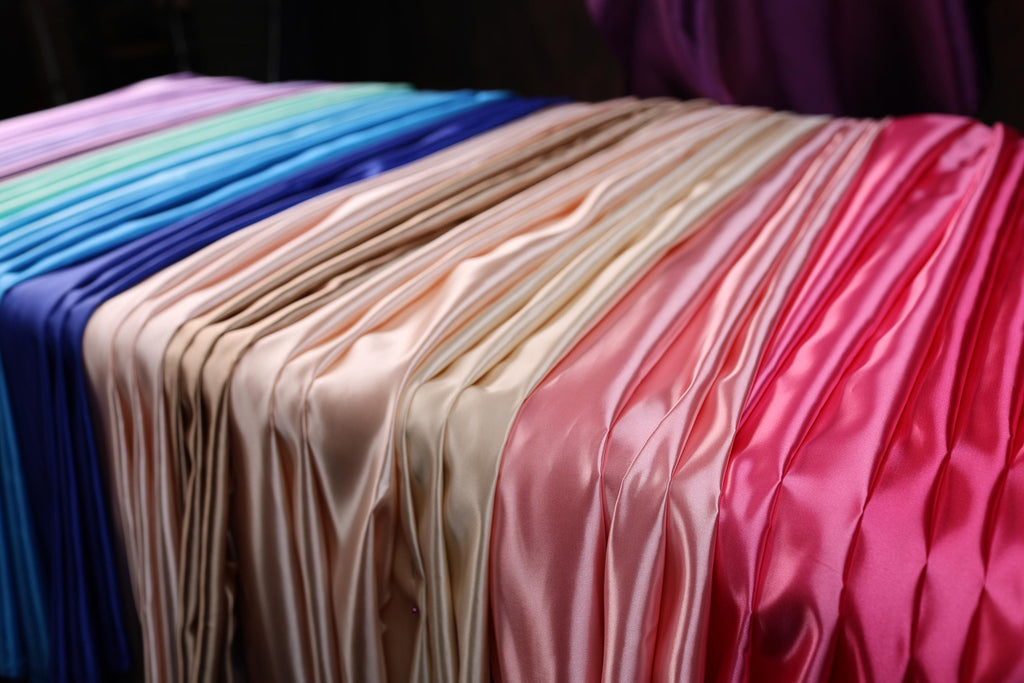 a row of different colored sheets of cloth