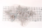 a delicate floral embroidery with a ruler placed on a white background.