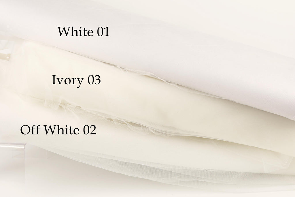 three different shades of white fabric, each labeled with a number.