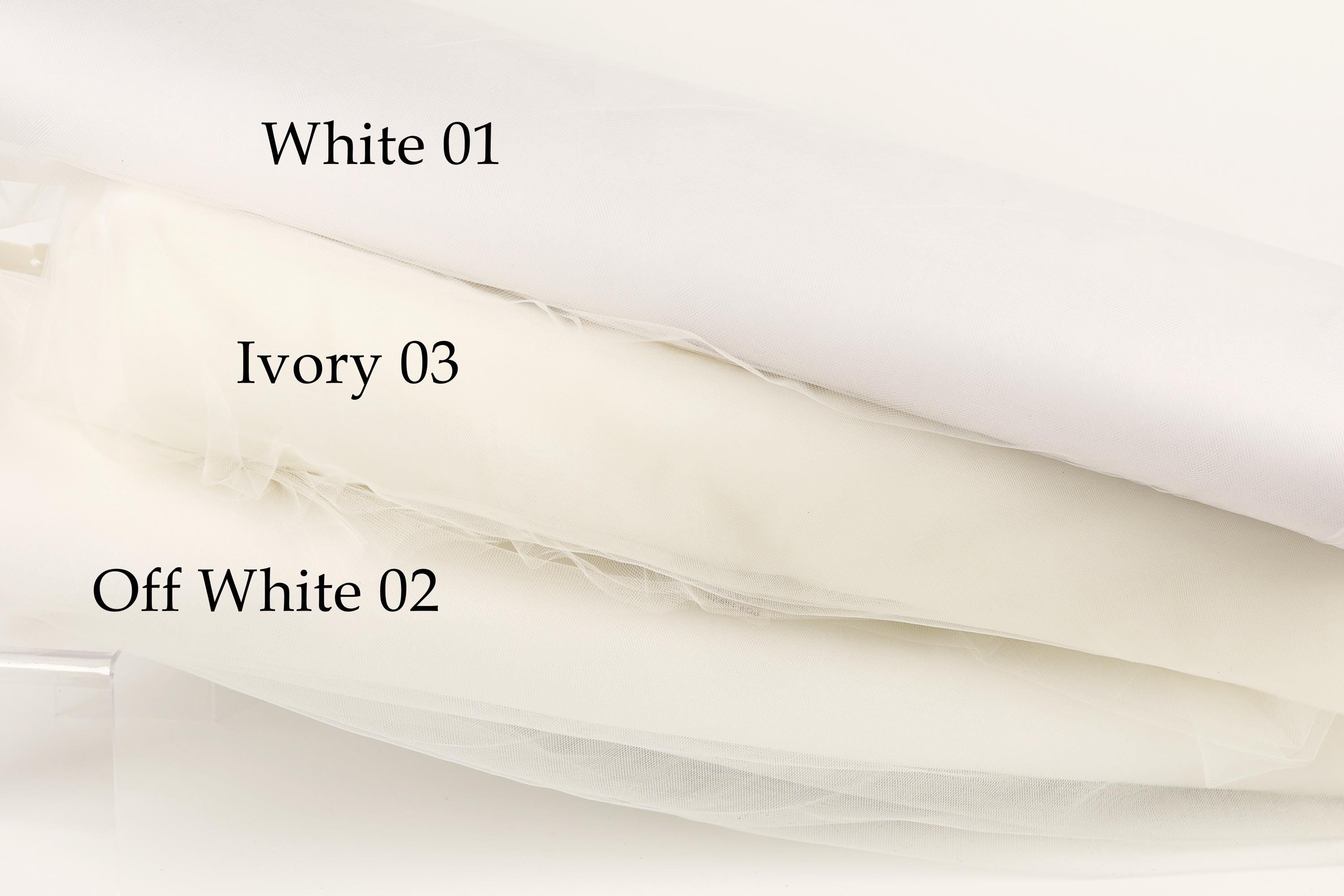 three different shades of white fabric, each labeled with a number.