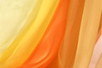 The image is a close-up of a fabric with a vibrant yellow, orange, and red gradient, creating a visually striking and colorful effect.