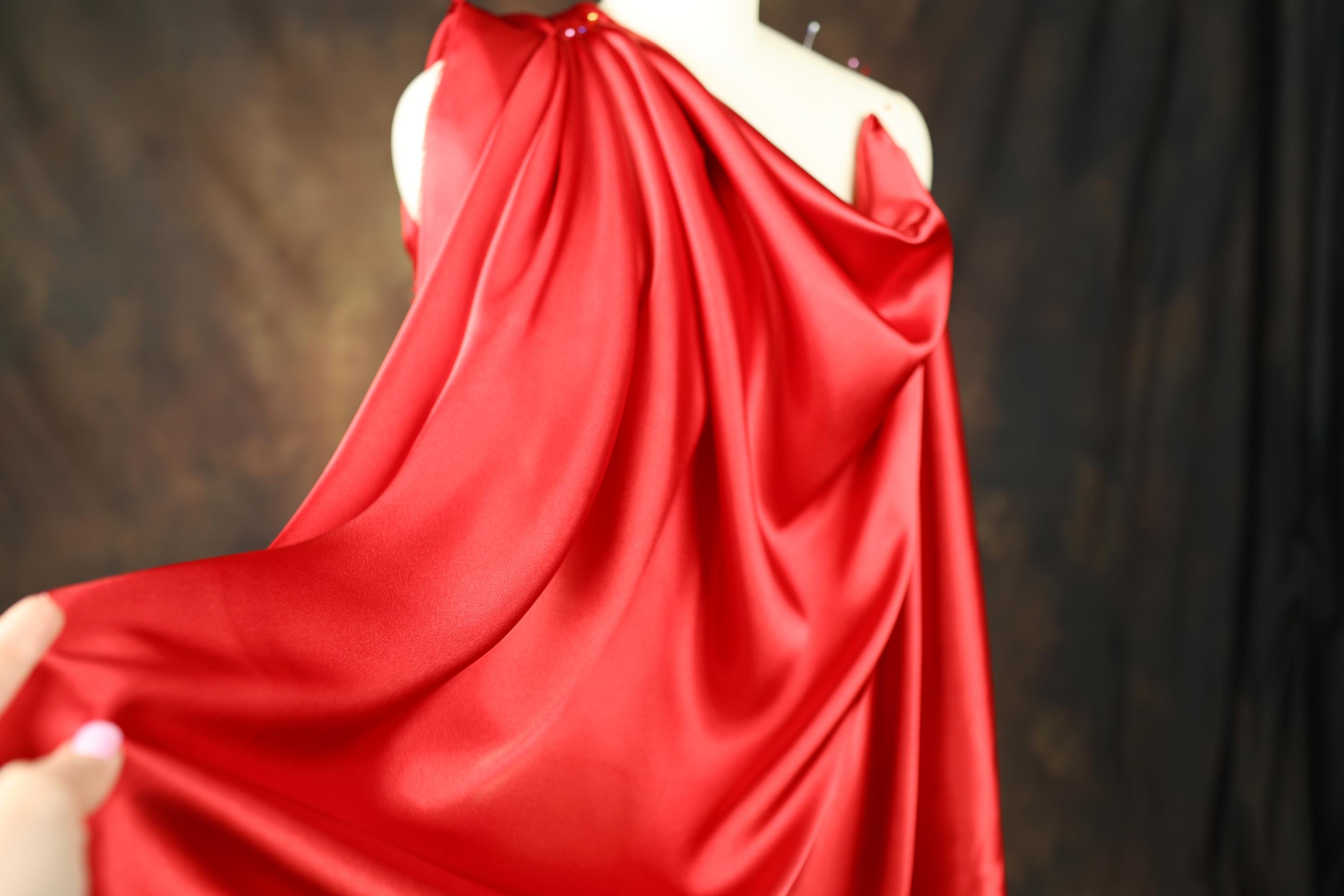 a woman in a red dress holding a red umbrella