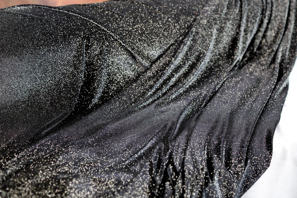 a close up of a woman's black dress