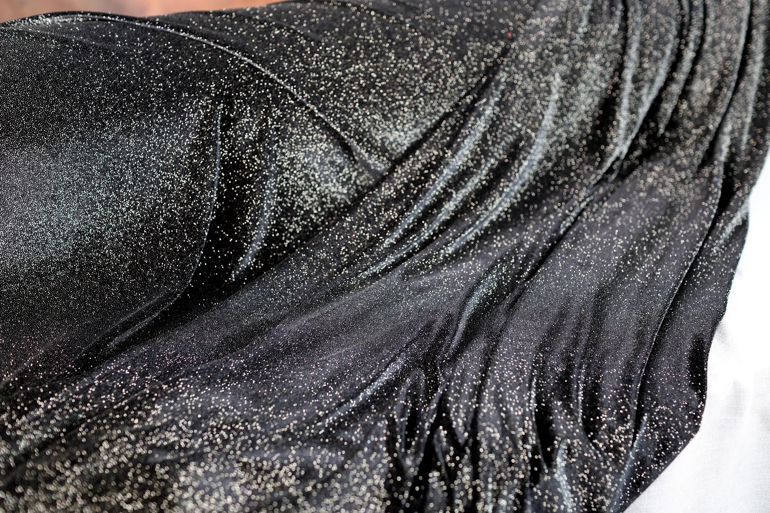 a close up of a woman's black dress