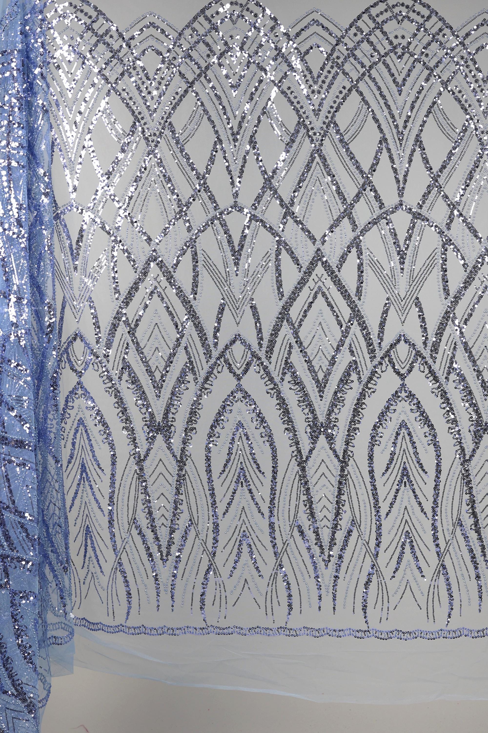 a close-up view of a fabric with a repeating pattern of silver sequins and lines, creating an intricate and visually striking design.