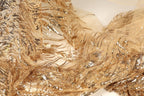 The image is a close-up of a fabric with a gold and beige color scheme, featuring a shimmering, sequined texture. The fabric appears to be made of sheer material, giving it a delicate and elegant appearance.