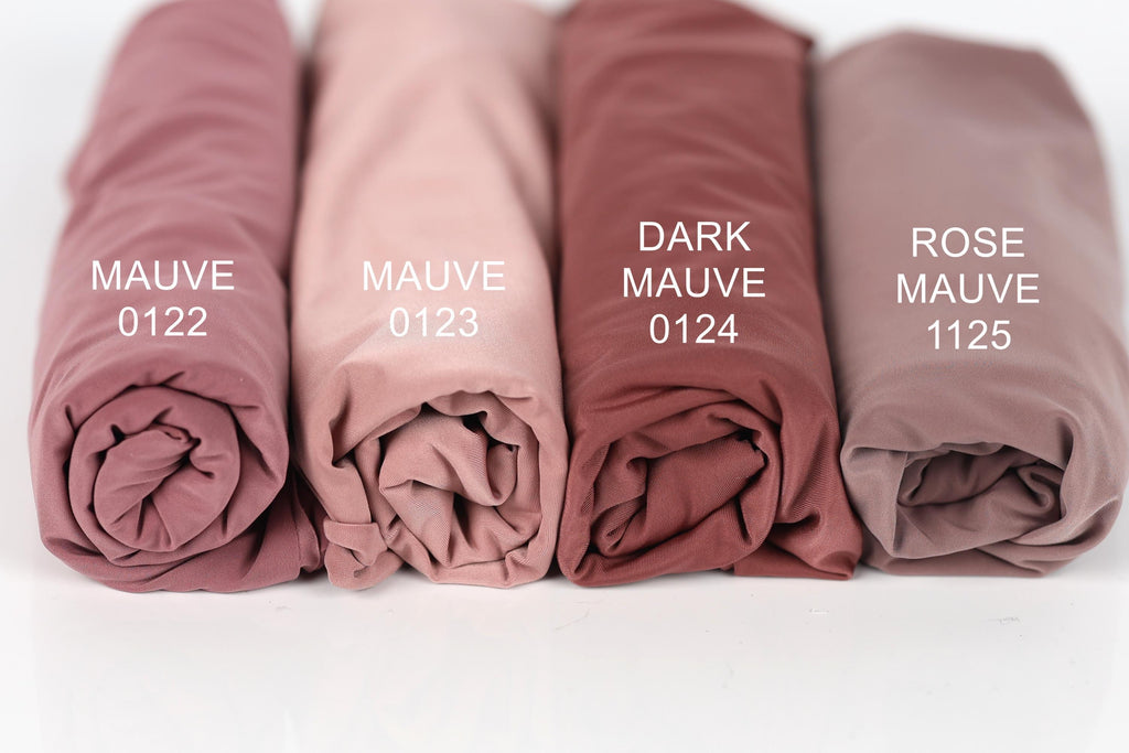 Four rolled-up fabric swatches in different shades of pink, labeled with the names "MAUVE 0122", "MAUVE 0123", "MAUVE 0124", and "MAUVE 1125".