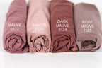Four rolled-up fabric swatches in different shades of pink, labeled with the names "MAUVE 0122", "MAUVE 0123", "MAUVE 0124", and "MAUVE 1125".